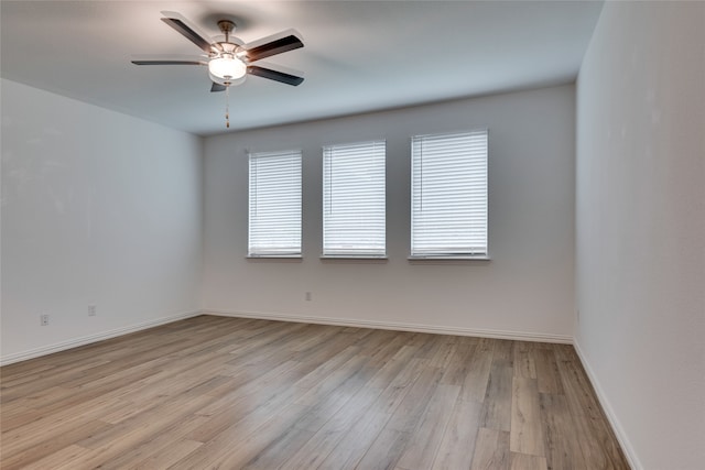 spare room featuring ceiling fan and light hardwood / wood-style floors