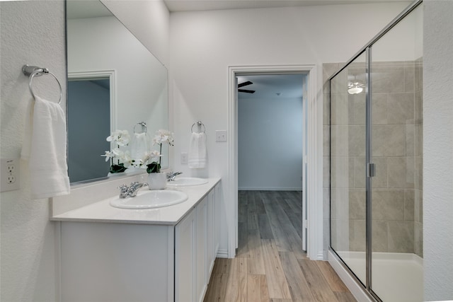 bathroom with an enclosed shower, vanity, and hardwood / wood-style flooring