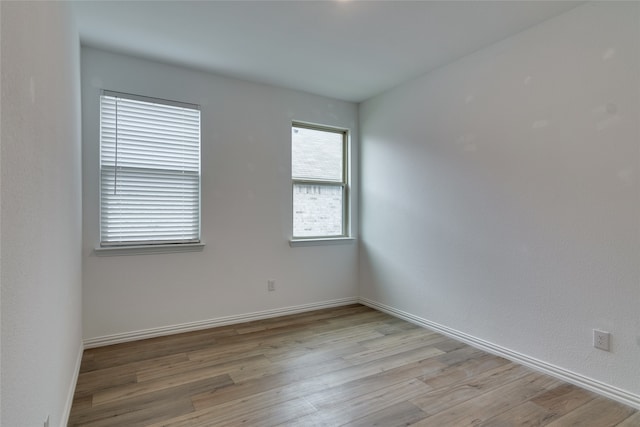 spare room with light hardwood / wood-style floors