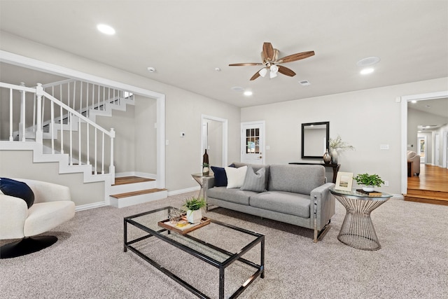 living room featuring ceiling fan and carpet floors