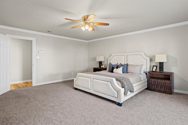 carpeted bedroom with crown molding and ceiling fan