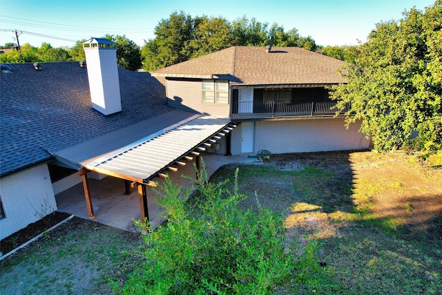 rear view of house featuring a patio and a yard