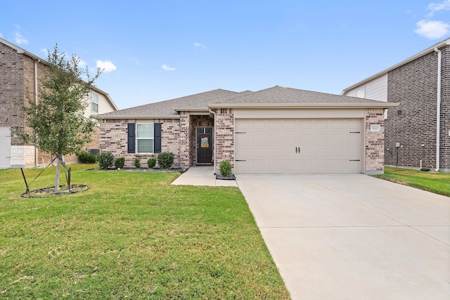 view of front of property featuring a garage and a front yard