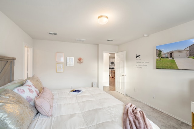 bedroom featuring light colored carpet