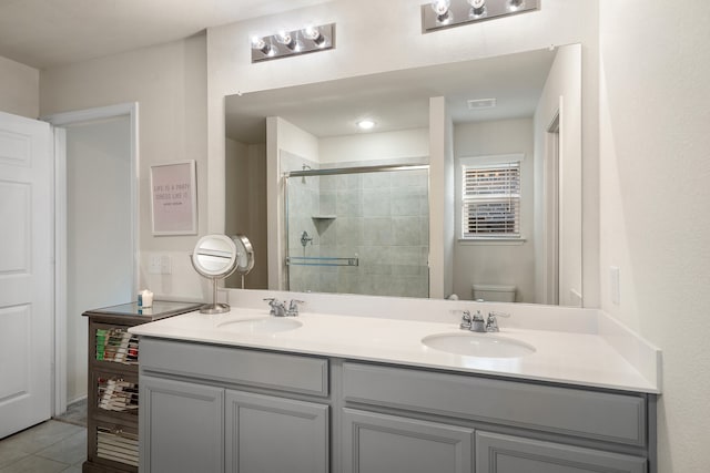 bathroom with walk in shower, tile patterned flooring, vanity, and toilet