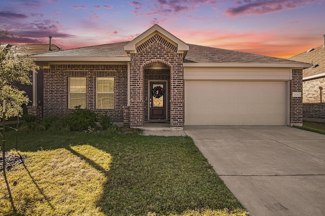 ranch-style house featuring a yard and a garage