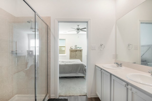 bathroom with walk in shower, hardwood / wood-style floors, vanity, and ceiling fan