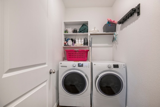 washroom with washing machine and clothes dryer