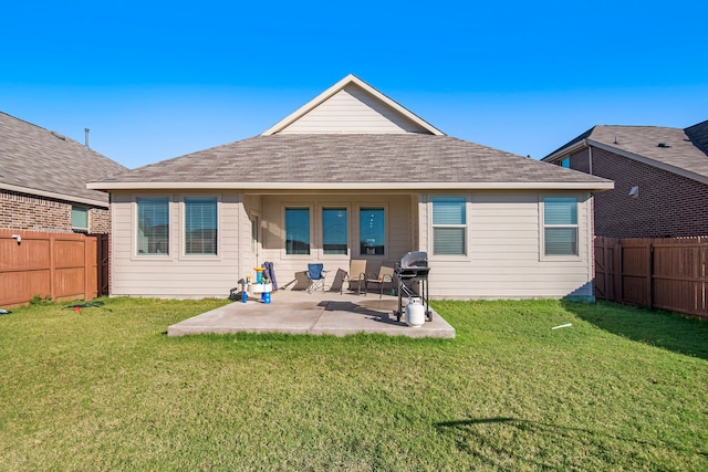 back of house with a yard and a patio