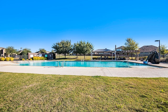 view of pool with a yard