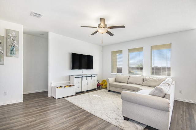 living room featuring dark hardwood / wood-style floors and ceiling fan