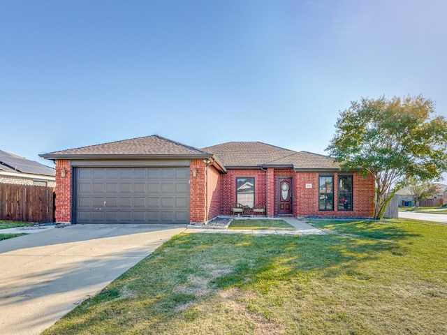 view of front of home with a garage and a front lawn