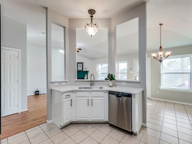 kitchen with light tile patterned flooring, sink, white cabinetry, vaulted ceiling, and dishwasher