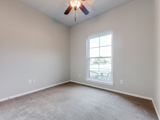 empty room featuring ceiling fan and carpet flooring