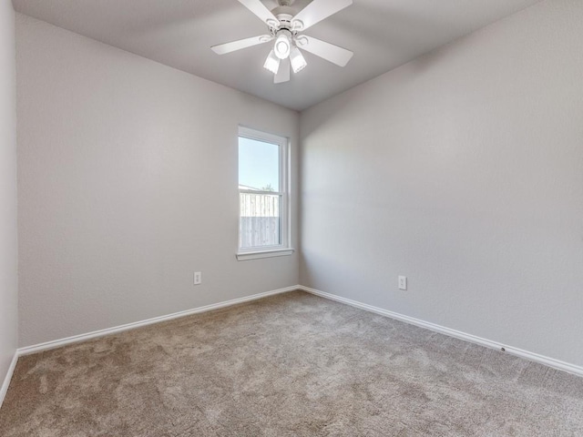 spare room featuring carpet and ceiling fan