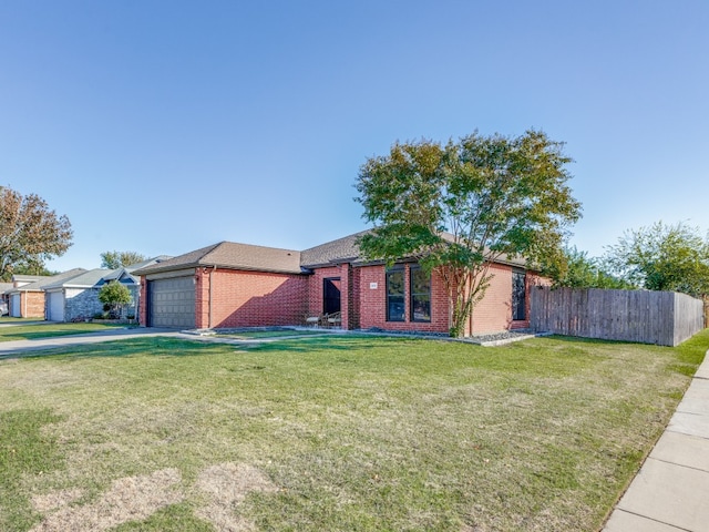 ranch-style home featuring a garage and a front yard