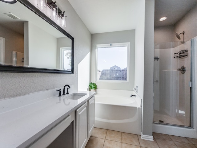 bathroom with tile patterned flooring, vanity, and independent shower and bath