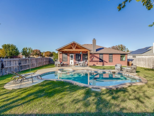 view of swimming pool with an in ground hot tub, a patio area, and a lawn