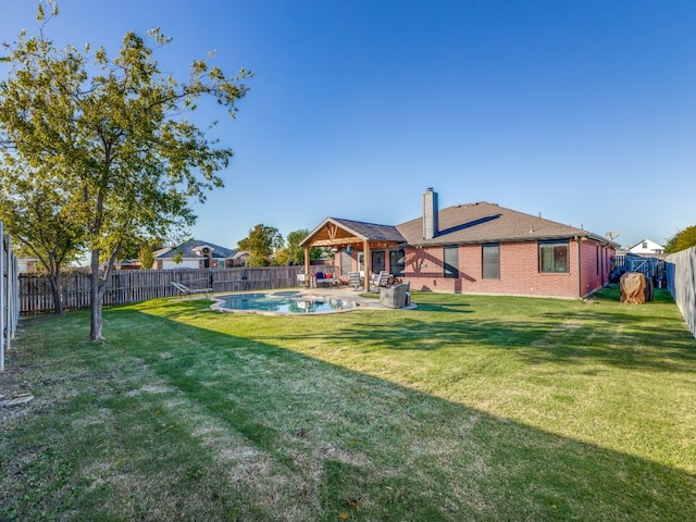 view of yard featuring a fenced in pool and a gazebo