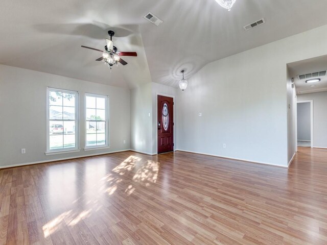 unfurnished living room featuring ceiling fan, vaulted ceiling, and light hardwood / wood-style floors