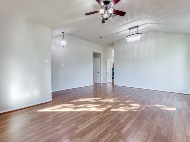 spare room with hardwood / wood-style flooring, lofted ceiling, and ceiling fan