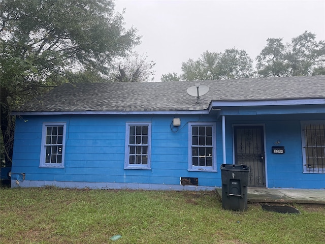 rear view of property with a lawn