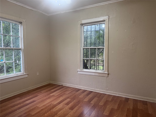 unfurnished room with hardwood / wood-style flooring, plenty of natural light, and crown molding