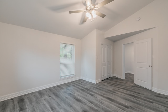 unfurnished bedroom featuring a closet, vaulted ceiling, dark hardwood / wood-style floors, and ceiling fan