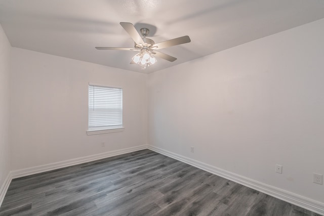 spare room with dark hardwood / wood-style flooring and ceiling fan