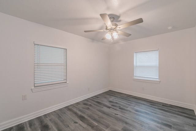 unfurnished room with dark hardwood / wood-style floors and ceiling fan