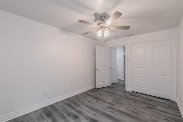 unfurnished bedroom with dark wood-type flooring and ceiling fan