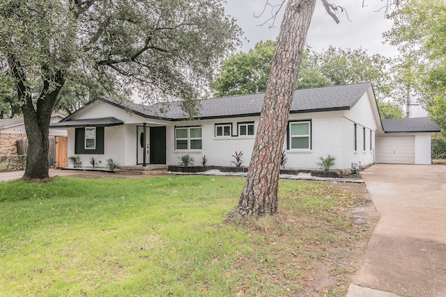 ranch-style home featuring a garage and a front lawn