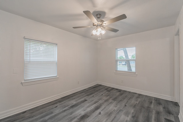 empty room featuring ceiling fan and dark hardwood / wood-style flooring