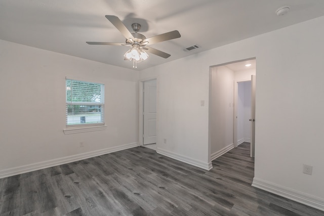 spare room featuring ceiling fan and dark hardwood / wood-style flooring