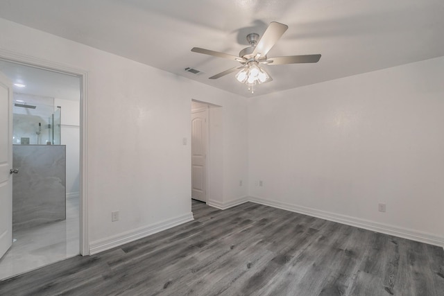 unfurnished room with ceiling fan and dark hardwood / wood-style flooring