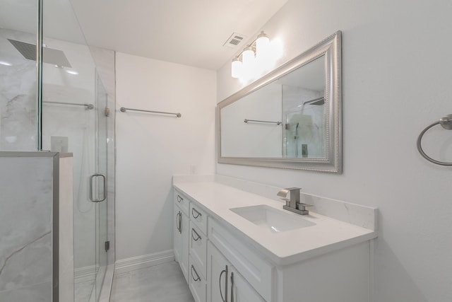 bathroom with vanity and a shower with door