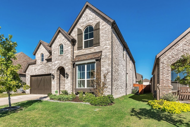 view of front of property with a garage and a front yard