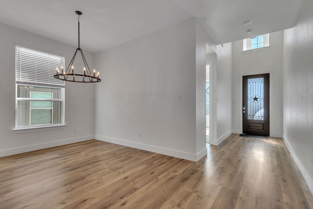 entryway with a chandelier and light hardwood / wood-style flooring