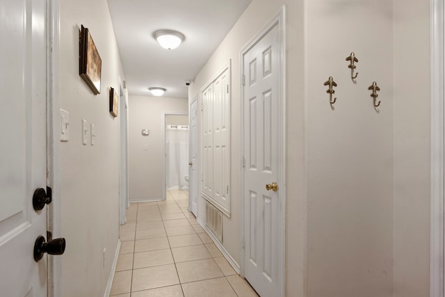 corridor with light tile patterned flooring