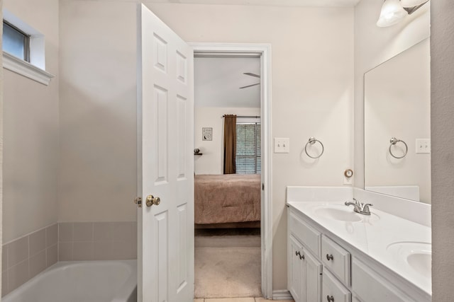 bathroom featuring a tub, vanity, and tile patterned floors