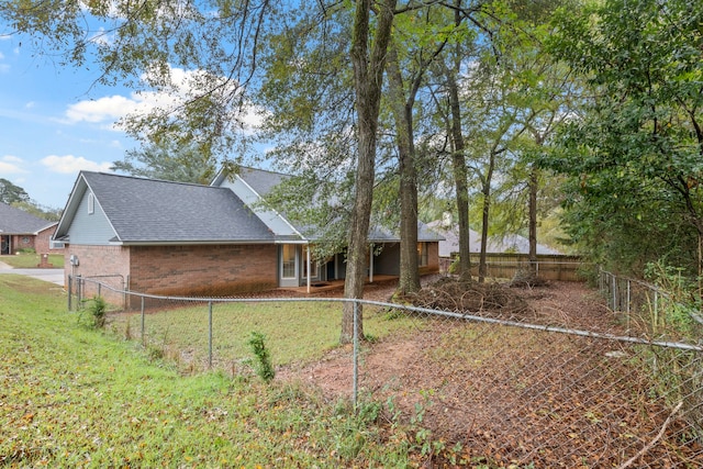 rear view of house with a lawn