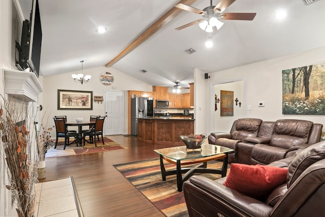 living room featuring dark hardwood / wood-style flooring, a stone fireplace, vaulted ceiling with beams, and ceiling fan with notable chandelier