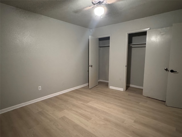 unfurnished bedroom with ceiling fan and light hardwood / wood-style flooring