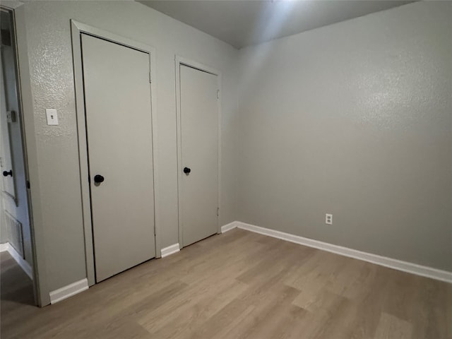 unfurnished bedroom featuring light hardwood / wood-style floors