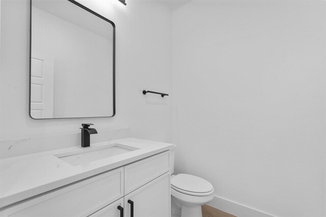 bathroom featuring vanity and toilet