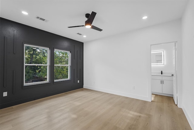 empty room with light wood-type flooring and ceiling fan