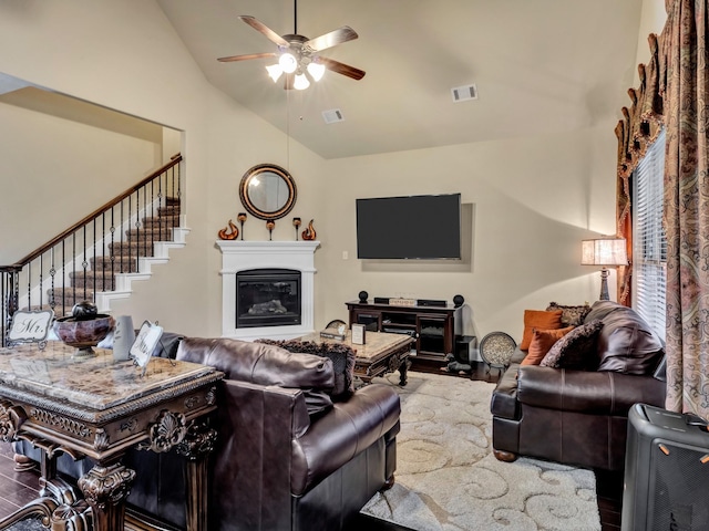 living room featuring hardwood / wood-style flooring, ceiling fan, and lofted ceiling