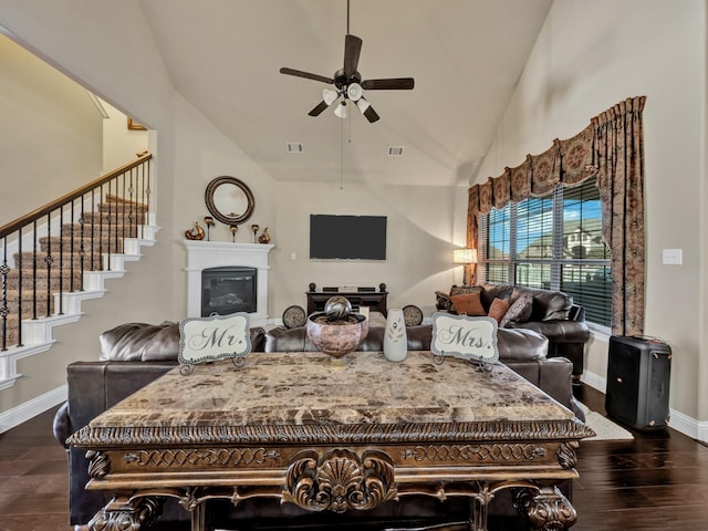 living room with high vaulted ceiling, ceiling fan, and dark wood-type flooring