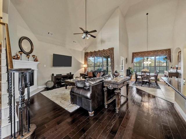 living room with ceiling fan, high vaulted ceiling, and hardwood / wood-style flooring