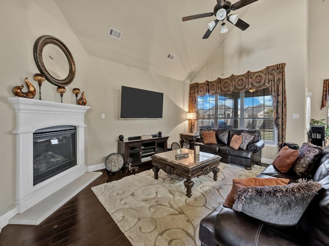 living room featuring high vaulted ceiling, ceiling fan, and dark wood-type flooring